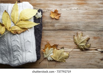 Pile Of Knitted Winter  Or Autumn Clothes On Wooden Background, Sweaters, Knitwear, Space For Text, Top View
