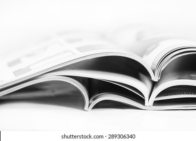 a pile of magazines close up on white background