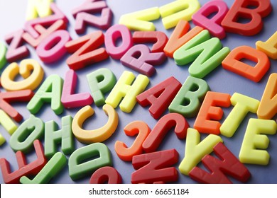 Pile Of Magnetic Letters With The Hidden Word 