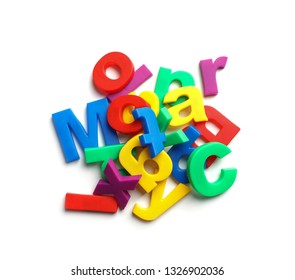 Pile Of Magnetic Letters Isolated On White, Top View