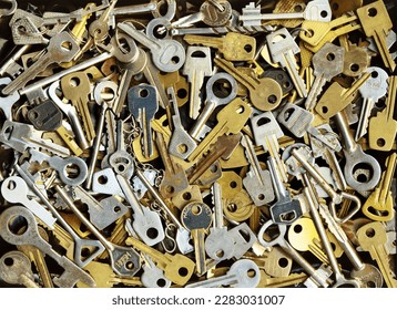 Pile of many different yellow and white old metal keys choice to open a door. Vintage close-up background - Shutterstock ID 2283031007