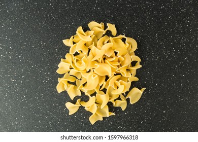 Pile Of Many Yellow Dehydrated Uncooked Egg Noodles