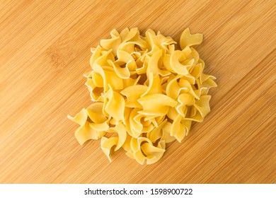 Pile Of Many Yellow Dehydrated Uncooked Egg Noodles