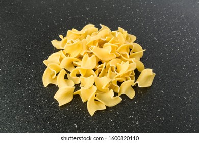 Pile Of Many Yellow Dehydrated Uncooked Egg Noodles