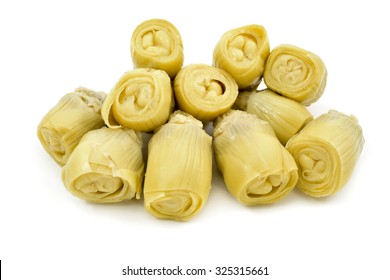 a pile of marinated artichoke hearts on a white background