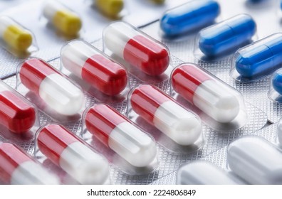 Pile of medical pills in white and red colors. Tablets in plastic packaging. The concept of healthcare and medicine. - Shutterstock ID 2224806849