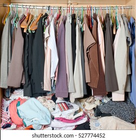 Pile Of Messy Clothes In Closet. Untidy Cluttered Woman Wardrobe.