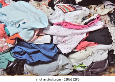 Pile Of Messy Clothes In Closet. Untidy Cluttered Woman.