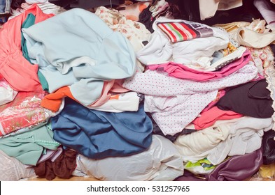 Pile Of Messy Clothes In Closet. Untidy Cluttered Woman.