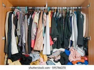 Pile Of Messy Clothes In Closet. Untidy Cluttered Woman Wardrobe.