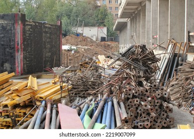 Pile Of Metal Pipeline Construction Materials, Iron Profiles, Steel Rods For Scaffolding On A Building Site. Renovation, Planning, Repair Modern Civil House. Concept Of Development Improvement Town