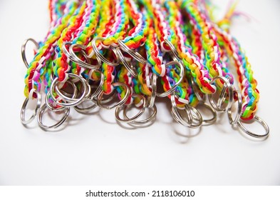 A pile of metal rings and colorful key chains isolated on white background with copy space