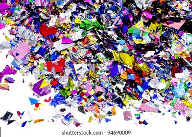 A Pile Of Metallic Confetti Of Different Colors On A White Background