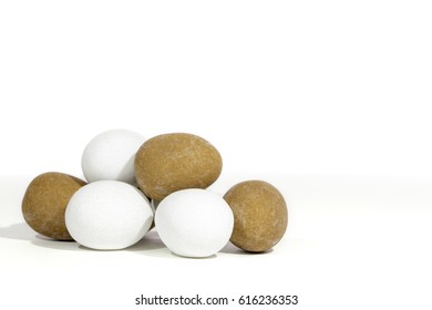 Pile of mini Easter eggs. Hand made sugar-coated candy truffles against white background with copy space.