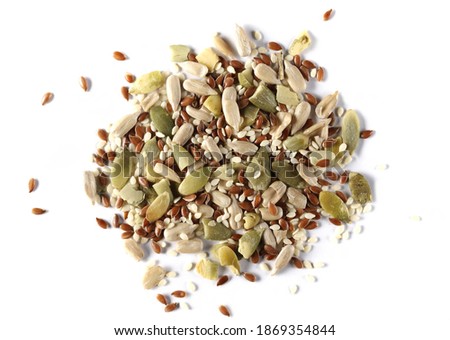 Pile mix seeds, sunflower, sesame, linseed and pumpkin seed isolated on white background, top view