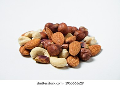 Pile Of Mixed Nuts And Dried Berries Isolated On White Background. Healthy High-calorie Vegan Food Concept. Close Up, Copy Space, Top View, Flat Lay.