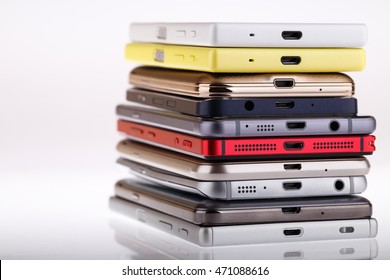 Pile Of Mobile Phone. Heap Of The Different Smartphones Isolated On White Background.