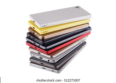 Pile of mobile phone. Heap of the different smartphones isolated on white background.
