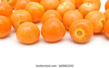 Pile of multiple physalis fruit berries isolated over the white background