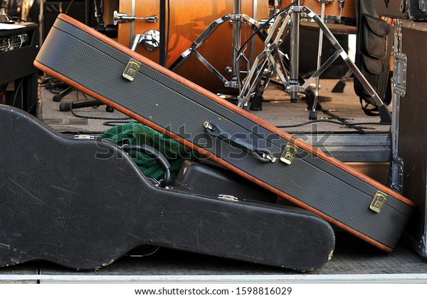 The Pile of Musical Instruments in Black Cases\
on Stage, closeup.