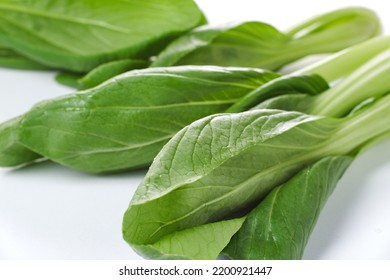 A Pile Of Mustard Greens On White Background