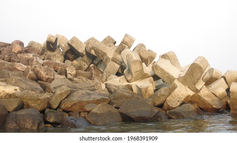 A pile of natural and manmade tetrapod breakwater or pemecah ombak alami dan buatan