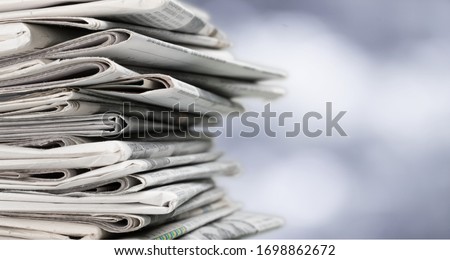 Pile of newspapers on blur background