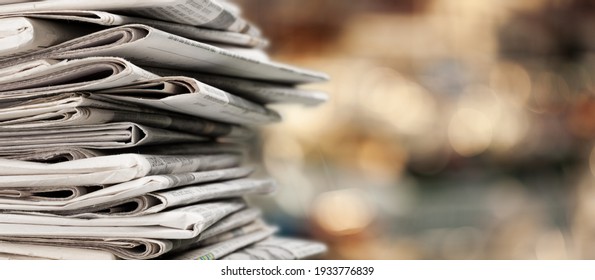 Pile of newspapers stacks on blur background
