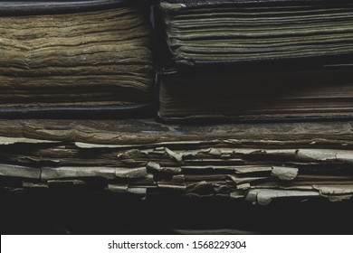 Pile of old, aged, dusty and dark books background side view - Powered by Shutterstock