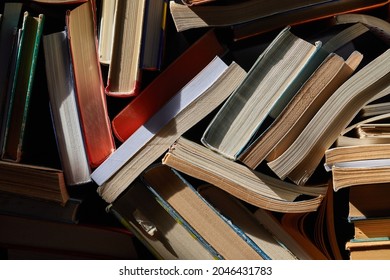 Pile Of Old Books In Dramatic Dim Light In The Attic, Forming Book Wall