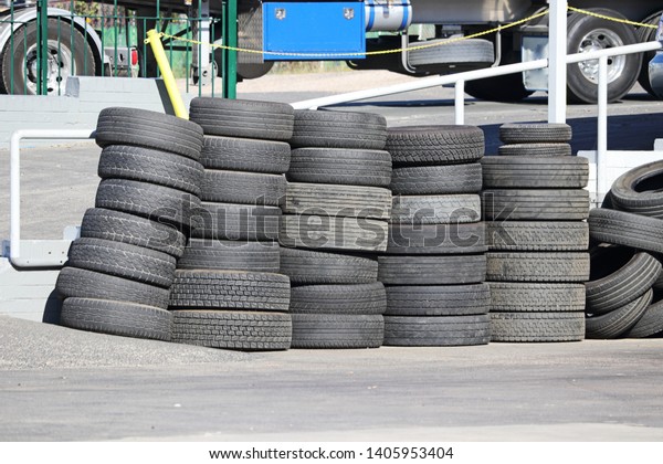 A pile of old car\
tires in a tire shop