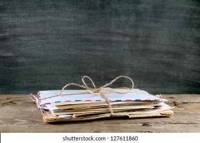 Pile Of Old Envelopes On Wooden Table