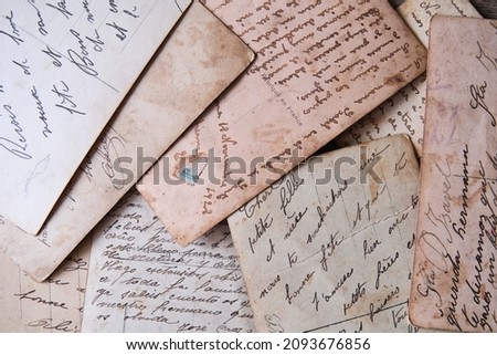 pile of old handwritten letters scattered on the table