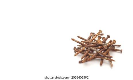 Pile of old and rusty construction carpentry nails on white