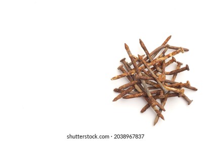 Pile of old and rusty construction carpentry nails on white