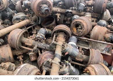 Pile Of Old Rusty Truck Axle For Reusing, Used Automotive Part For Sale, Old Rear Differential Of Truck, Car Rear Axle On Junk Yard