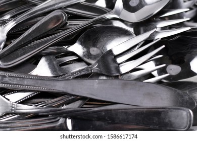 Pile Of Old Scratched And Dull Flatware In Need Of Polishing