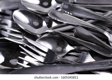 Pile Of Old Scratched And Dull Flatware In Need Of Polishing