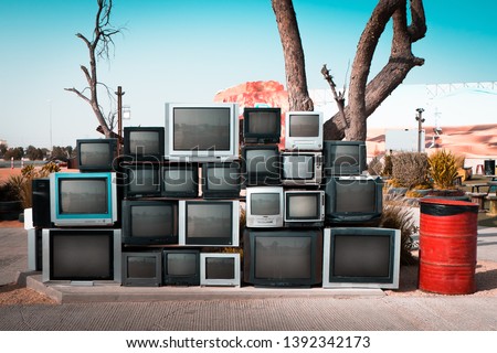 Pile of old televisions displayed along the road