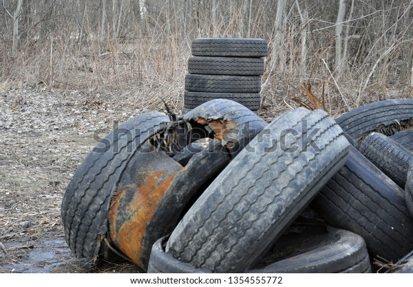Pile of old tires and wheels for rubber recycling.
Tyre dump