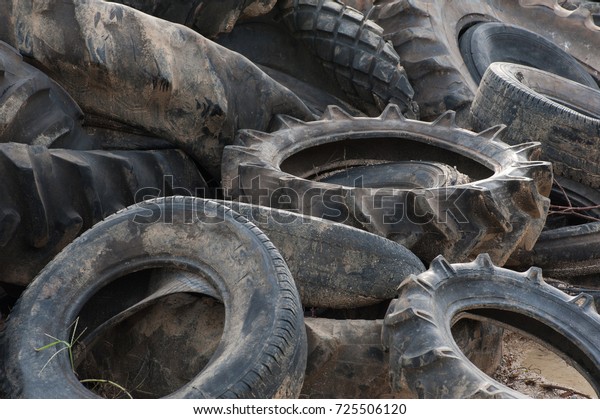 Pile of old\
tires and wheels for rubber\
recycling.