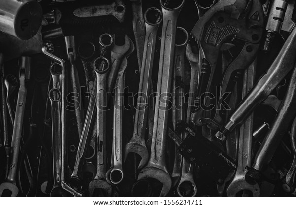 Pile of old wrench. Mechanic tools. Closeup set\
of spanner in tool box. Chrome wrench at garage workshop. Equipment\
for repair car or motorcycle. Hardware for technician service. Many\
size of wrench.
