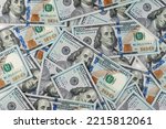 pile of one hundred US banknotes. Background with money american hundred dollar bills. 100 bills background. Lots of dollar bank notes on the table