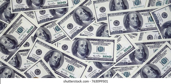 A pile of one hundred US banknotes with president portraits. Cash of hundred dollar bills, dollar background image with high resolution