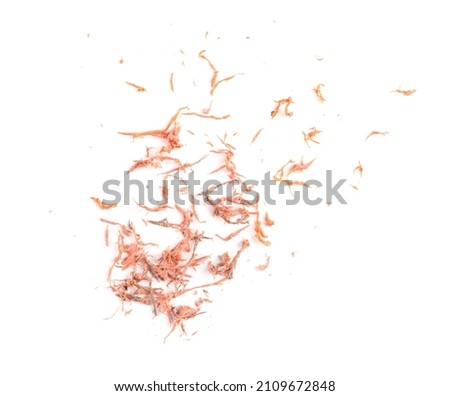 Pile of orange eraser crumbs on white background, top view