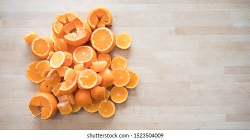 A Pile Of Orange Pieces On A Butcher Block Background.  Space For Text.