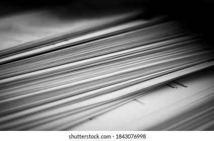 A pile of paper with selective focus on certain sheets. There can be seen a part of English text where it is written "entitled" and "Greece". - Shutterstock ID 1843076998