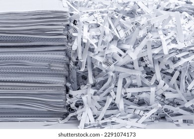 A pile of papers next to scraps from destroyed company documents - Shutterstock ID 2291074173