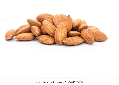  A Pile Of Peeled Almonds On White Background With Copy Space, Healthy Food Concept..