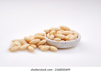 Pile of peeled or blanched almonds. White bowl of peeled whole almonds on white background. Shallow depth of field - Shutterstock ID 2160035699